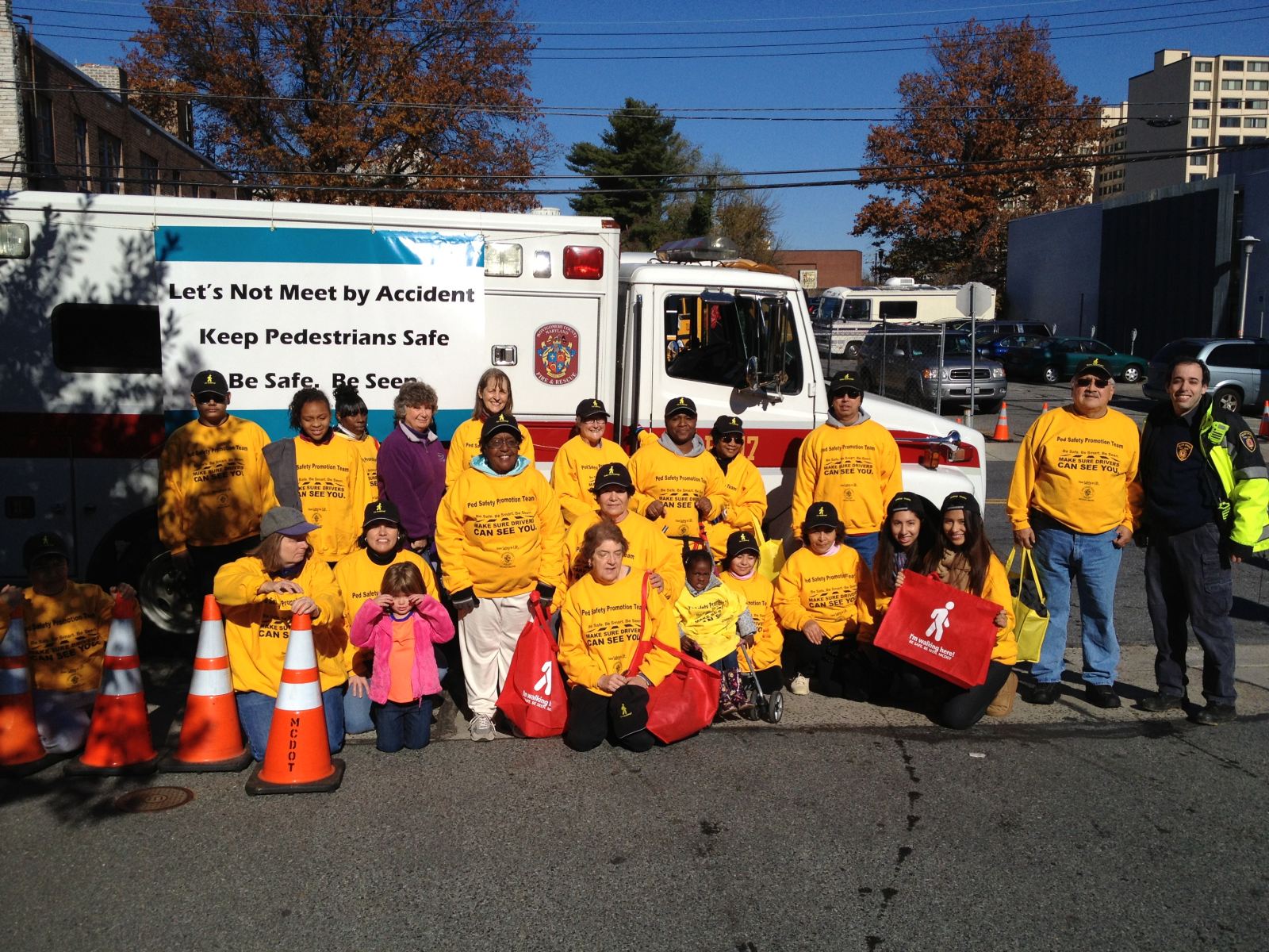 Photo of pedestrian safety volunteer team and Silver Spring Fire Rescue ambulance at 2012 Montgomery County Thanksgiving Parade