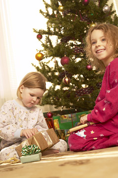 Holiday Safety photo of two kids and Christmas tree