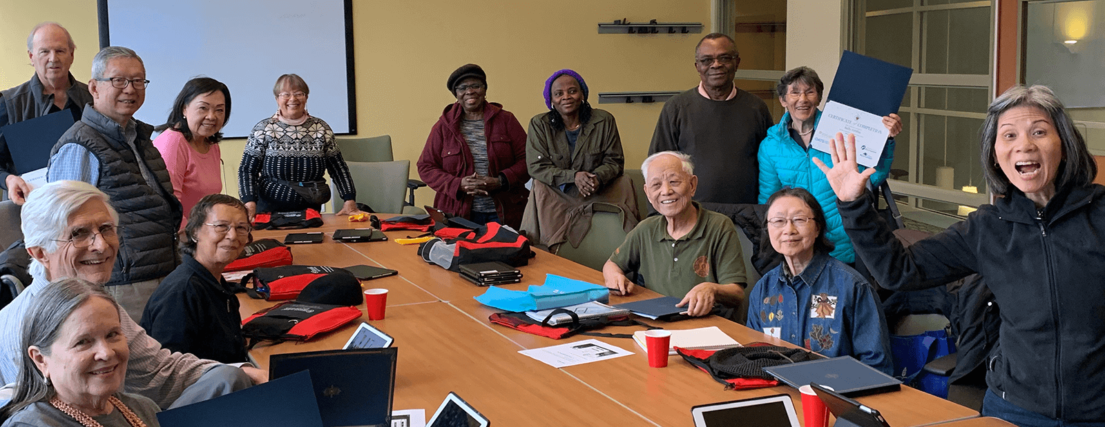 Digtal Equity Slider - Image of a group of seniors learning to use technology