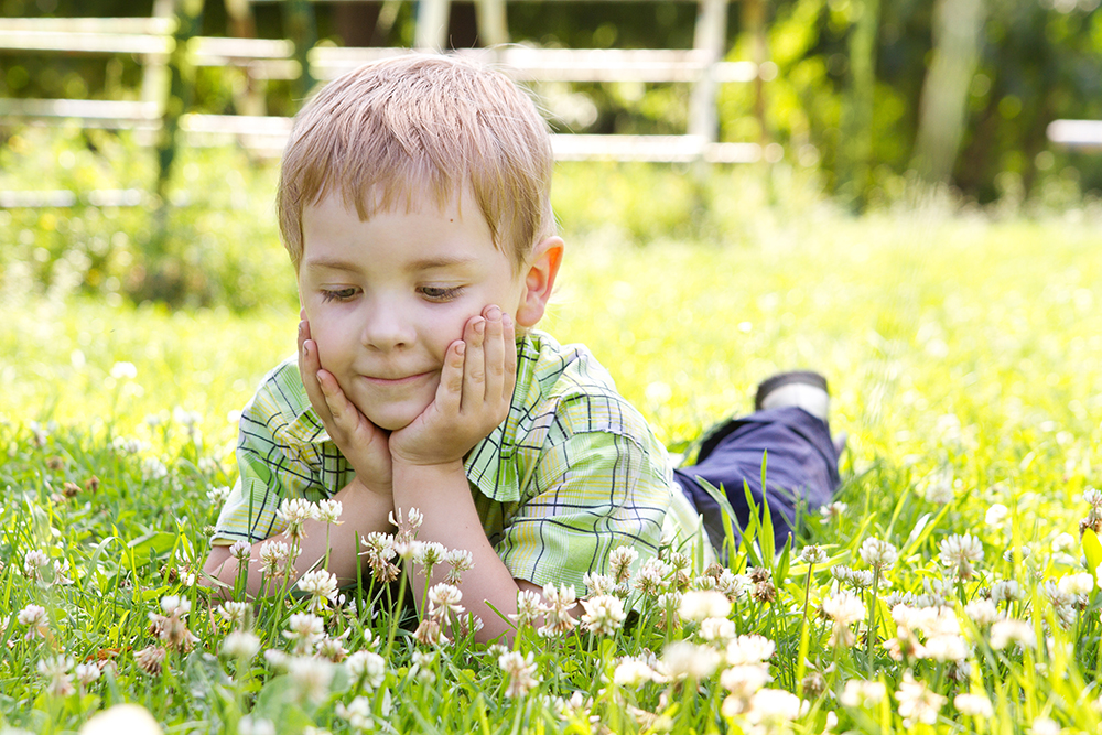 Child in grass with clover