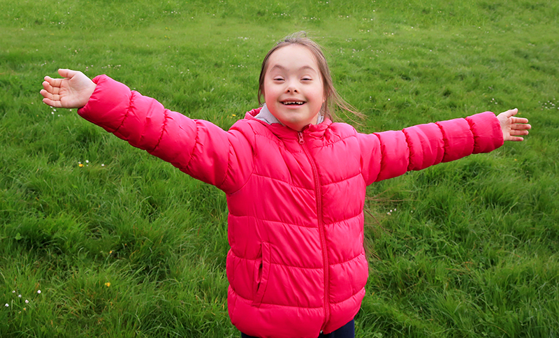 Girl enjoying time on grass. 