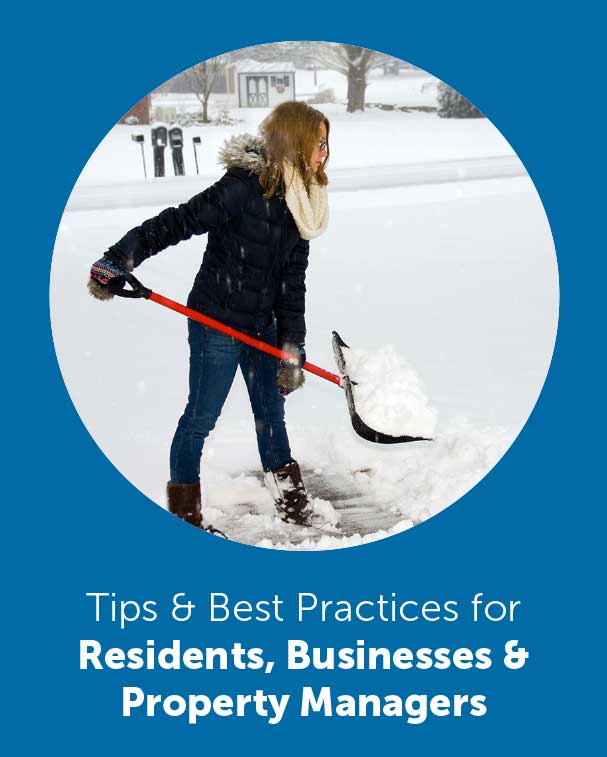 woman wearing snow jacket shoveling snow in driveway