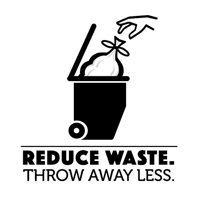 trash bag being placed in trash bin - reduce waste. throw away less.