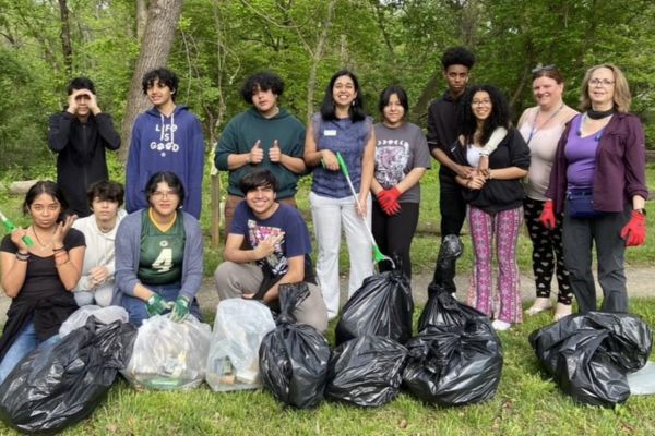 volunteers with full bags of trash
