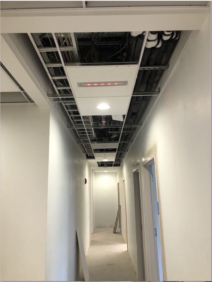 Hall 115 ceiling grid roughed in and exit sign being installed.