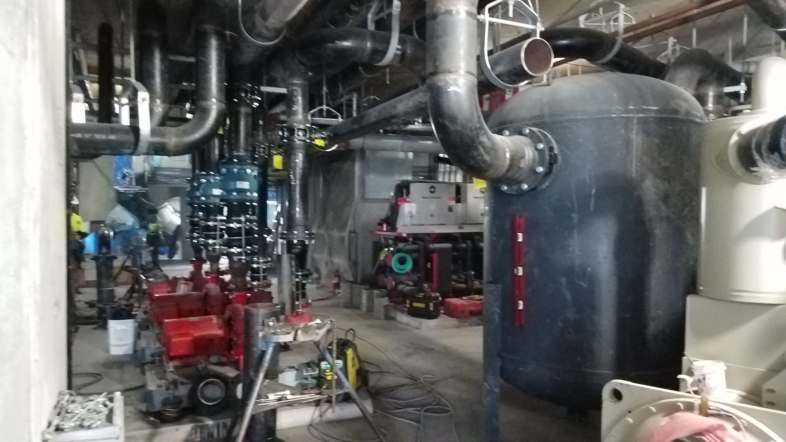 View of ongoing equipment installation in pool mechanical room
