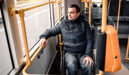 image of a man in a wheelchair riding a bus