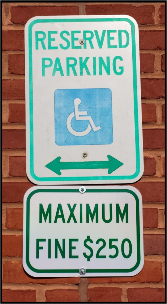 Reserved Parking and Maximum Fine $250 Signs posted on a building.