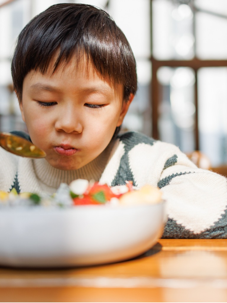 Asian child eating healthy meal