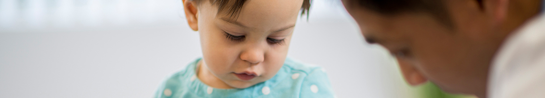 Child sitting with a doctor during an examination.