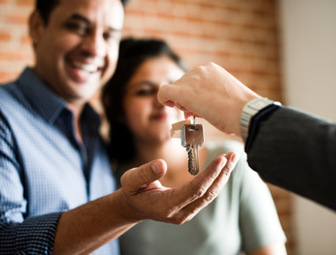 A couple being handed a set of keys