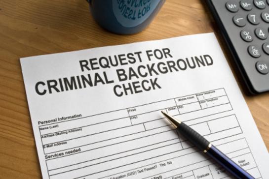 Paper background check request on a desk