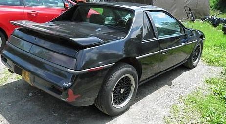 Example of a black Pontiac Fiero - A witness observed a black Pontiac Fiero in the parking lot of the store during the time frame of the murder.