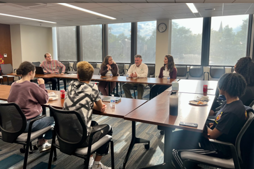 students at a meeting