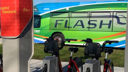 Bikeshare station with FLASH bus in background