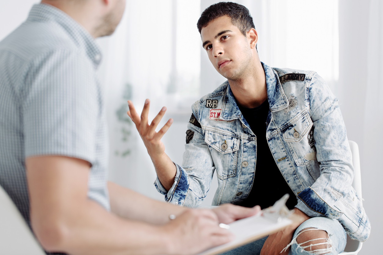Young Latino Man Talking to Other Man