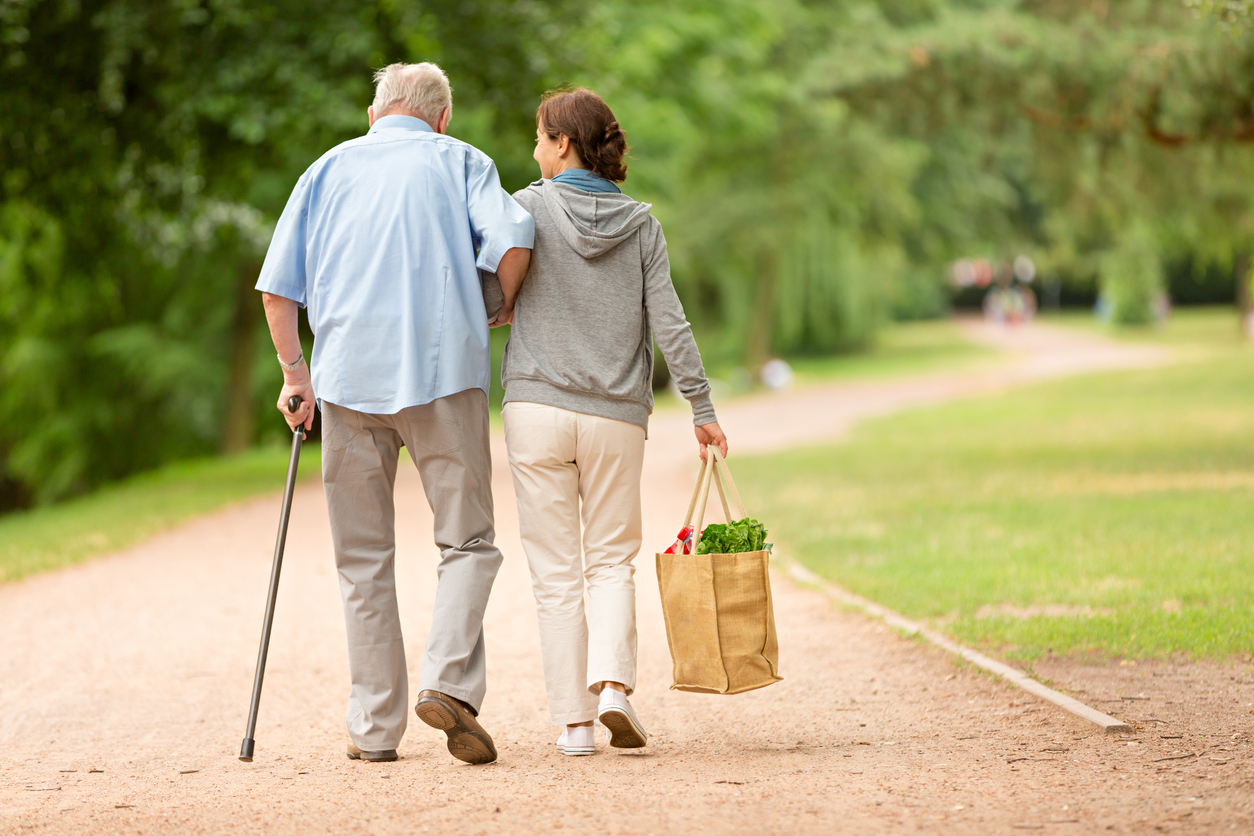 Woman walking with older gentleman