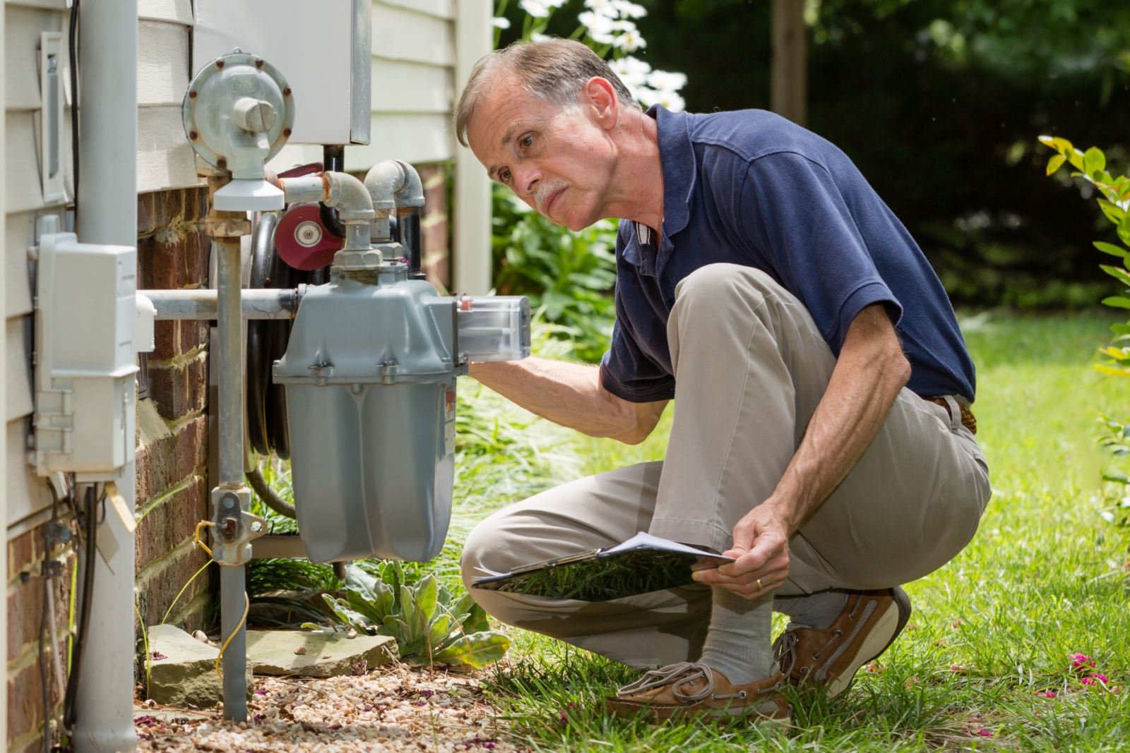 man inspecting energy status of home