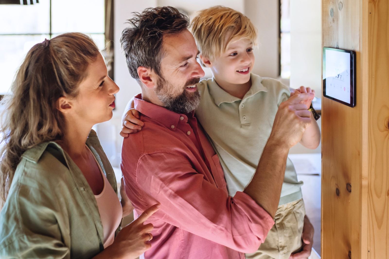 family adjusting indoor thermostat
