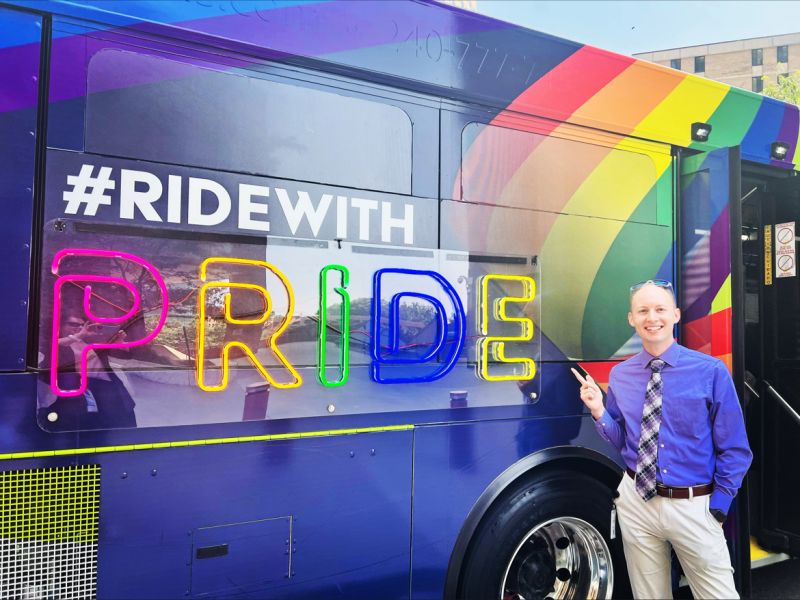 Ride with Pride sign on the side of a Ride On Bus. 