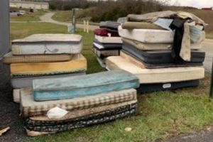 a pile of water saturated mattresses stored outside