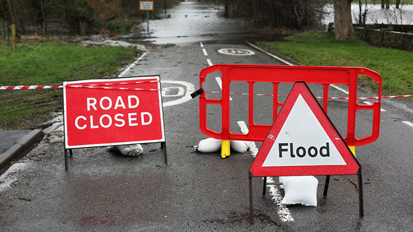 street signs close off flooded road