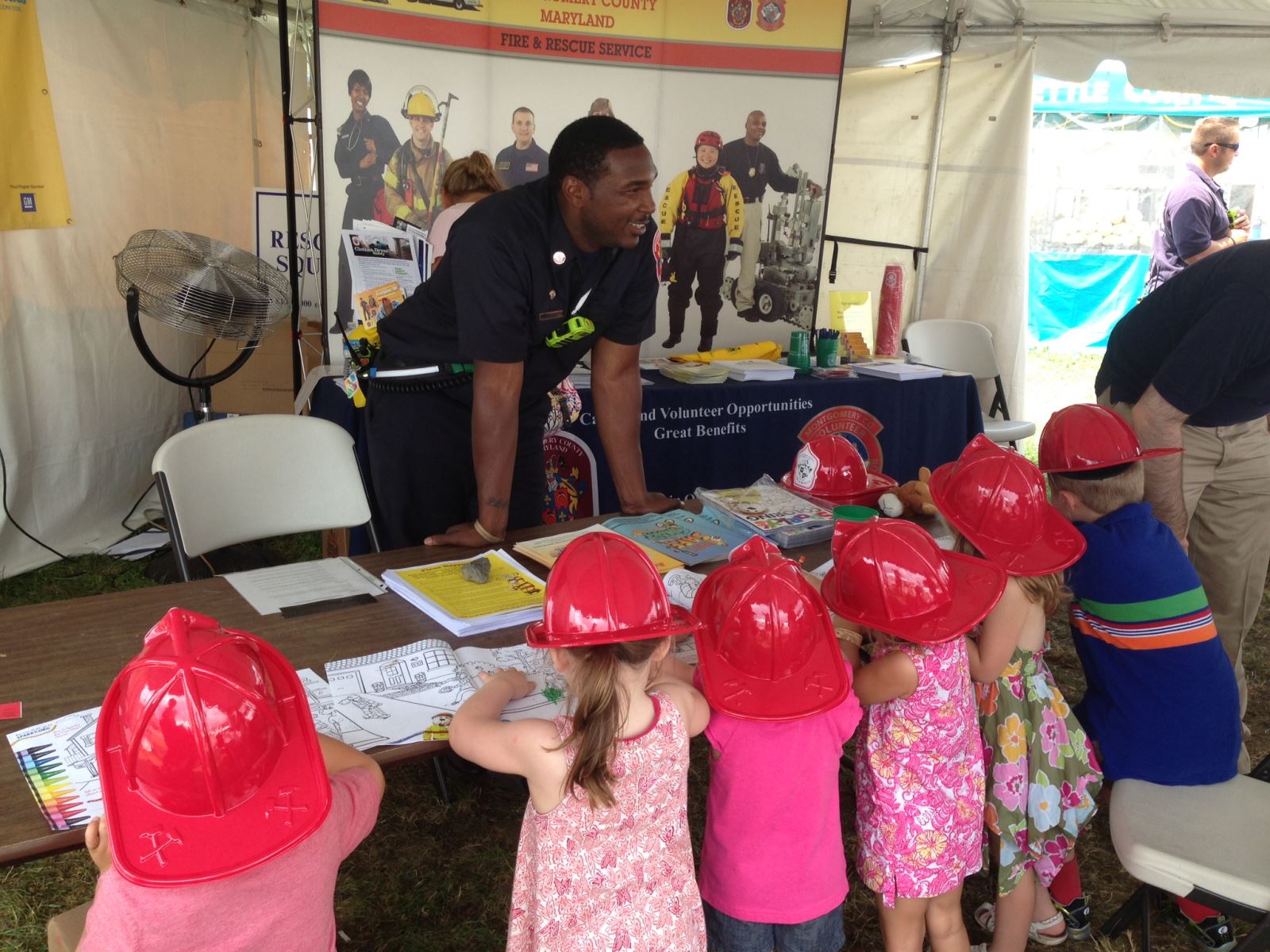 Firefighter with kids around him
