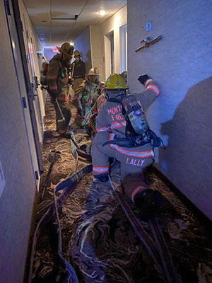 Group of fire fighters preparing to enter a room