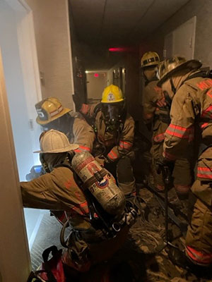 Fire fighters entering a smoke filled room