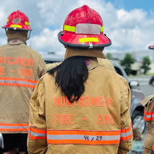 Multiple firefighters in full protective equipment viewed from behind