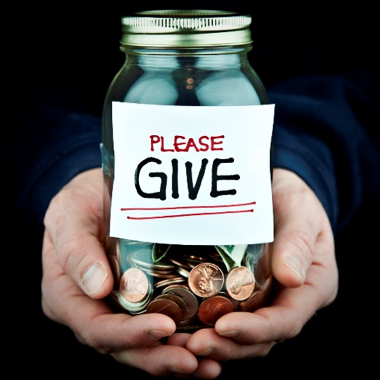A jar labeled 'Please Give' used to collect donations