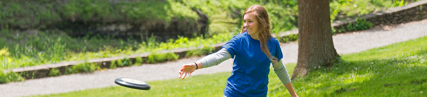teenager throwing frisbee