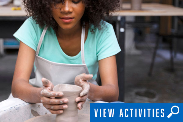 lady in pottery class, click to register for arts and crafts