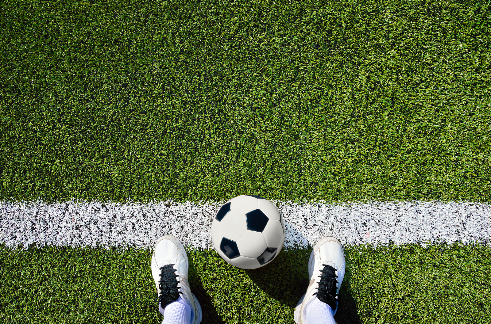 soccer ball and cleats on grass