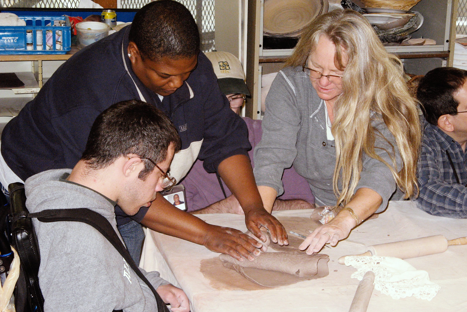 participant and aides rolling dough